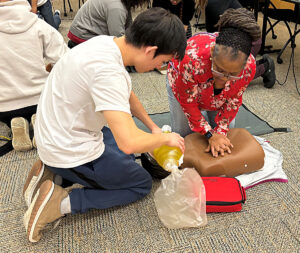 Physician’s Assistant, Kathy Lightfoot, doing a hands-on skills training during a Basic Life Support (BLS) course.