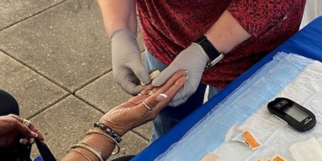 NIDA IRP Nurse Susan Sawyer providing health screenings at Baltimore County African American American Cutlural Festival